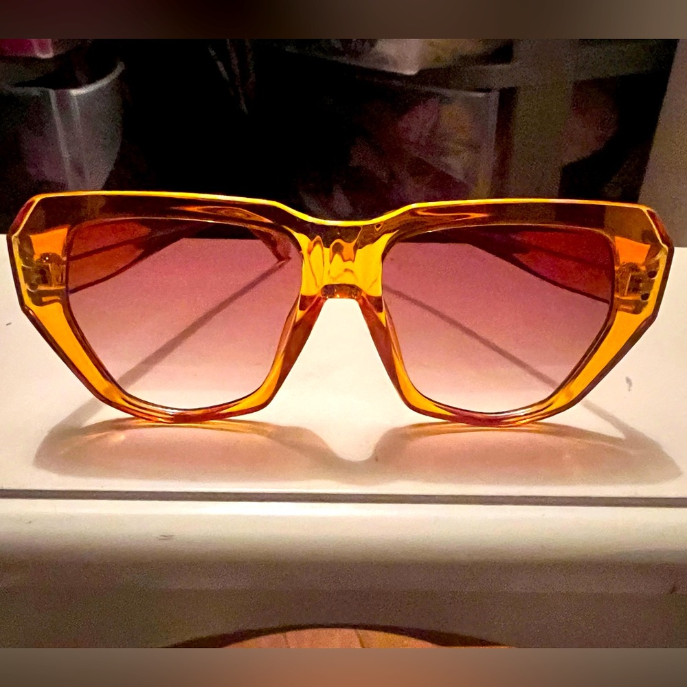 Orange sunglasses with very light purple amber lenses